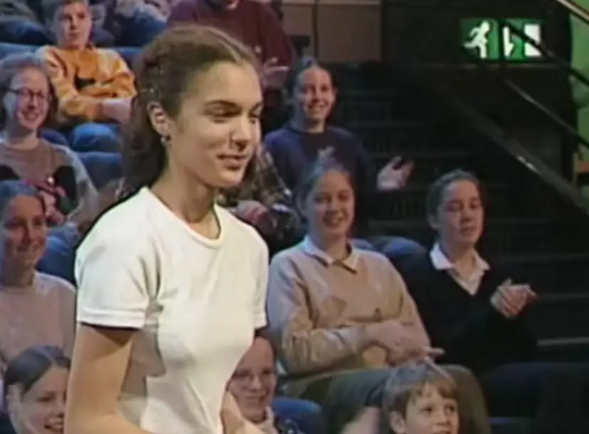 A teenager walking to the stage of the Ri Theatre