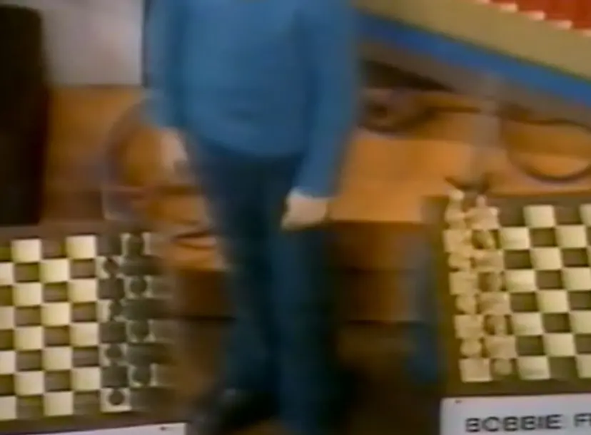 Two chess sets on the floor, in between a child 