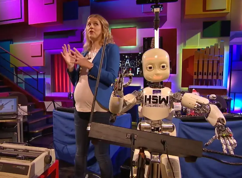 Danielle George  standing next to a robot in the Ri Theatre