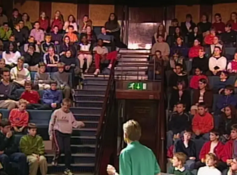 Neil Johnson talking to a crowd of children in the Ri theatre
