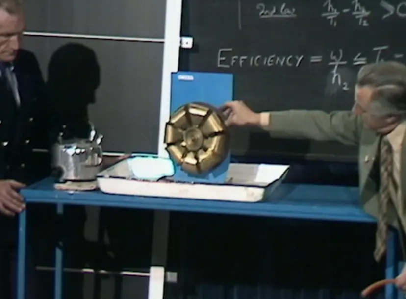 George Porter spinning a small golden fan in the Ri theatre