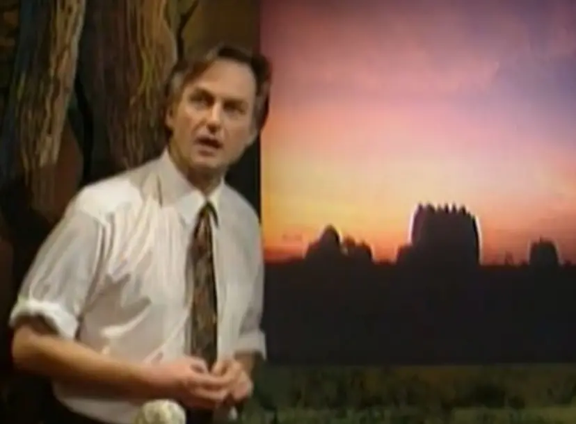 Richard Dawkins speaking in front of a dark green backdrop