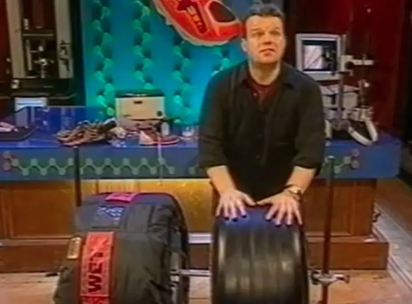 Tony Ryan standing behind two tyres in the Ri theatre