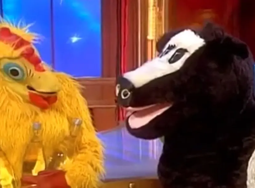 A person in a chicken costume and a person in a cow costume