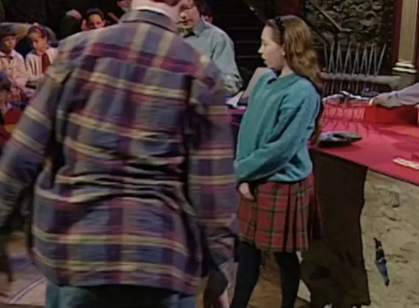 A man with his back turned and a child in the Ri theatre