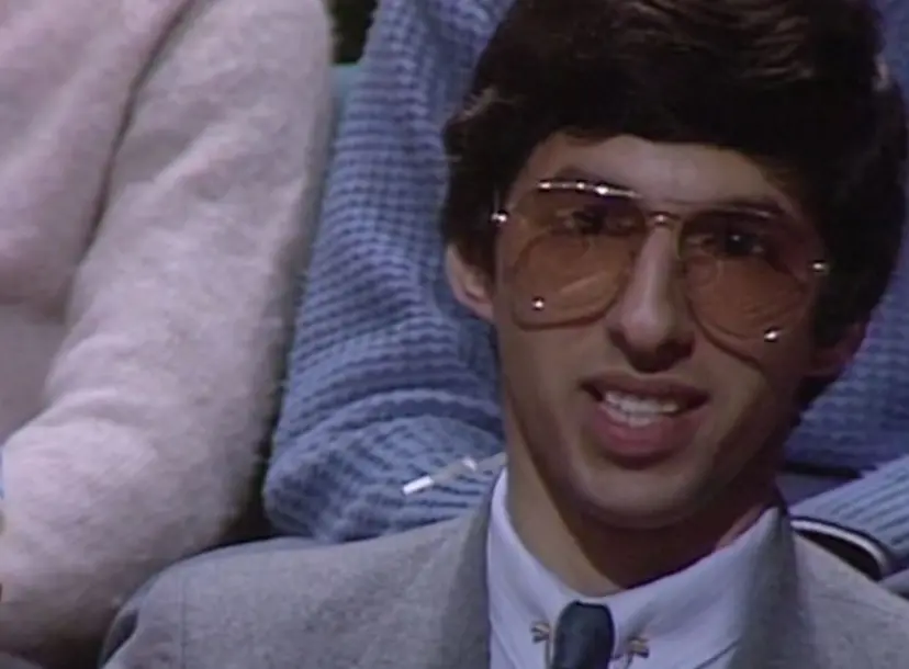 A man in glasses speaking from the seats in the Ri theatre