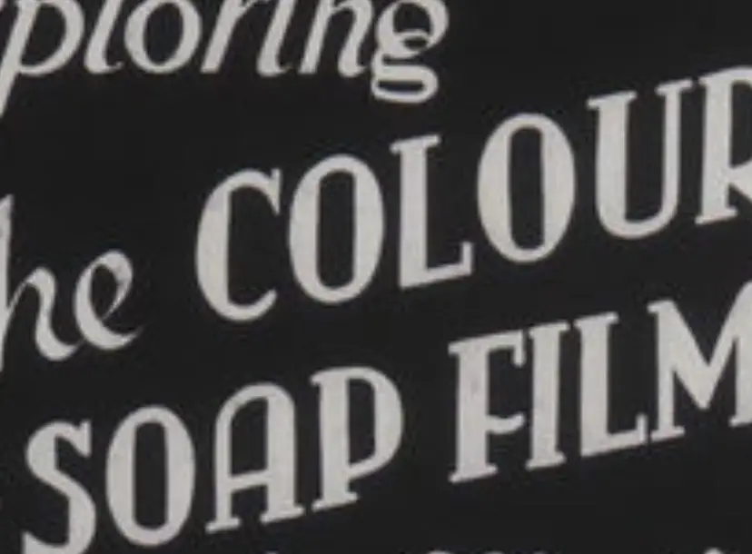 still from the soap film series, with printed text saying 'THE COLOURS OF SOAP FILMS' written in cursive