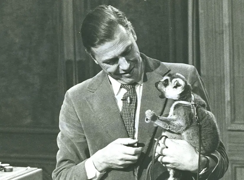 David Attenborough on the set of his Christmas Lectures, holding Tammy the lemur