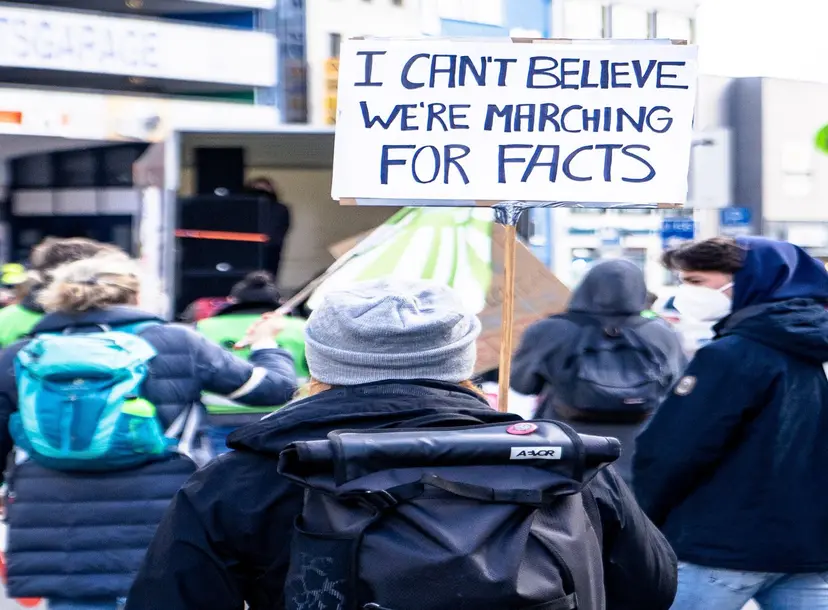 people holding sign at a protest 