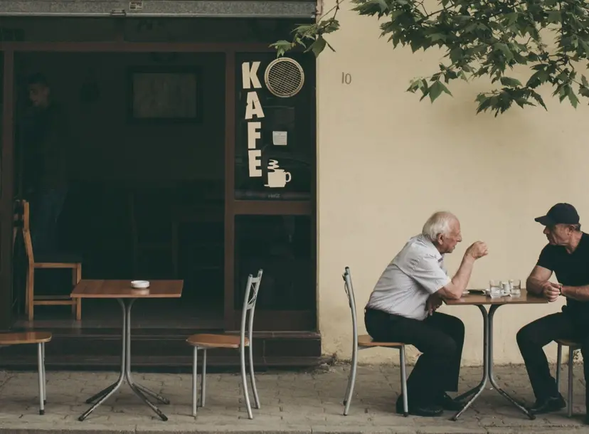 Men conversing outside a house
