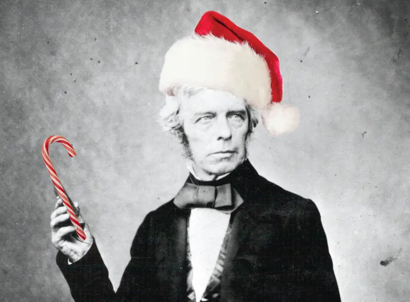 A picture of Michael Faraday, with a bright red hat and a candy cane photoshopped on him