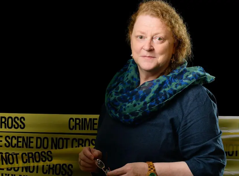 Sue Black stands in front of crime scene tape