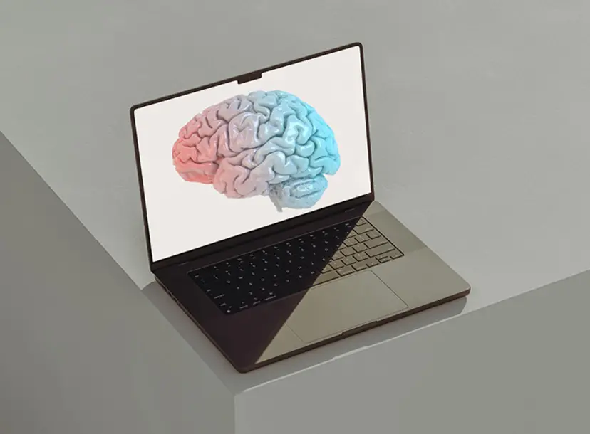 A laptop with a digital illustration of a brain on screen