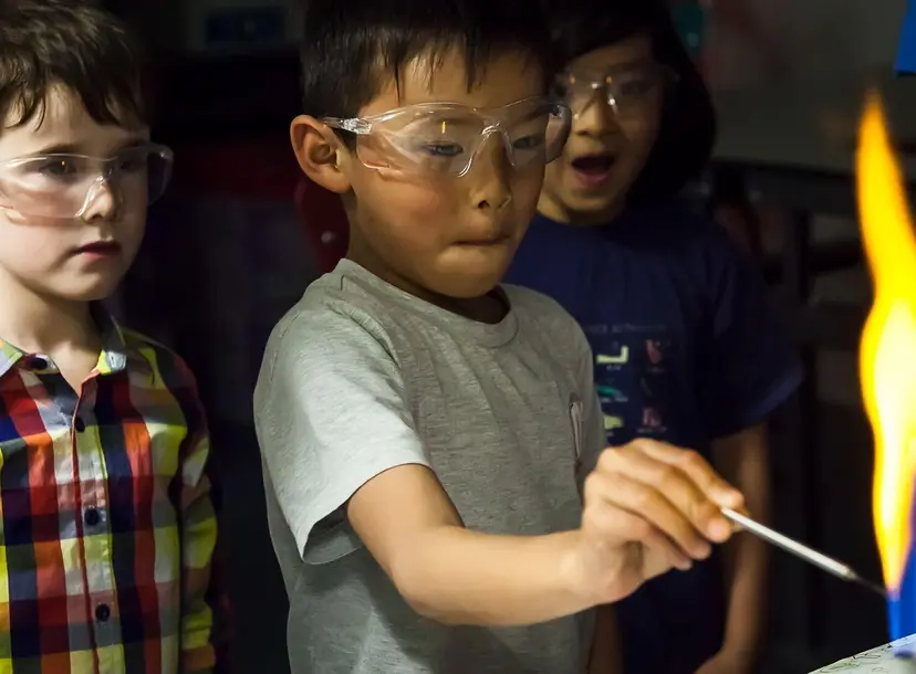 Children looking at a flame during a family fun day