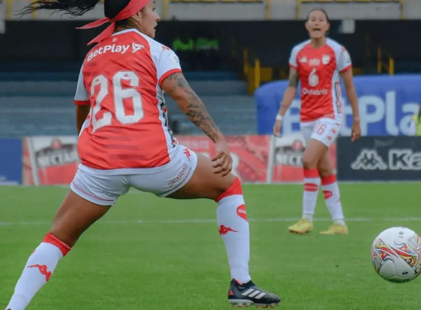 Two women playing football.