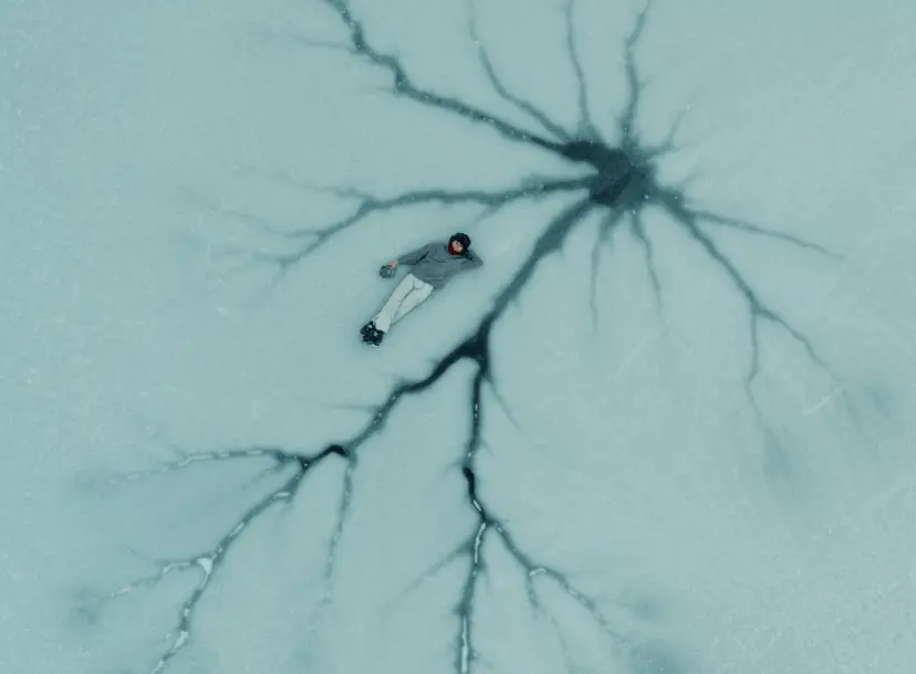 A person lying in a neuron network, sculpted in snow.