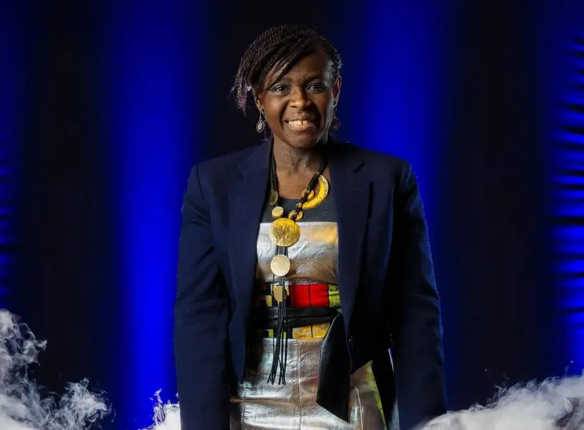 Maggie stands in the Theatre at the Faraday desk
