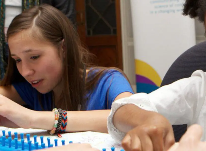 Volunteer and young participant getting stuck in at an Ri Family Fun Day