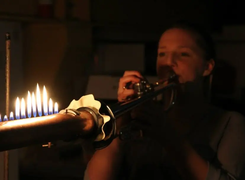 Anna plays a fire trumpet