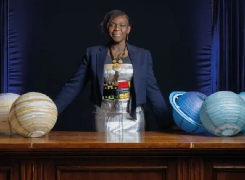 Image of Dame Maggie Aderin-Pocock in the Ri theatre with planets