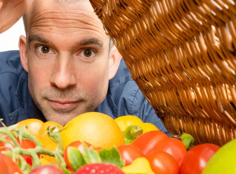 Chris van Tulleken looking inside a food rattan basket
