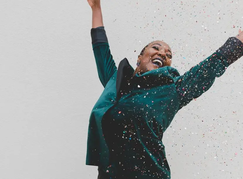 Woman celebrates as confetti falls