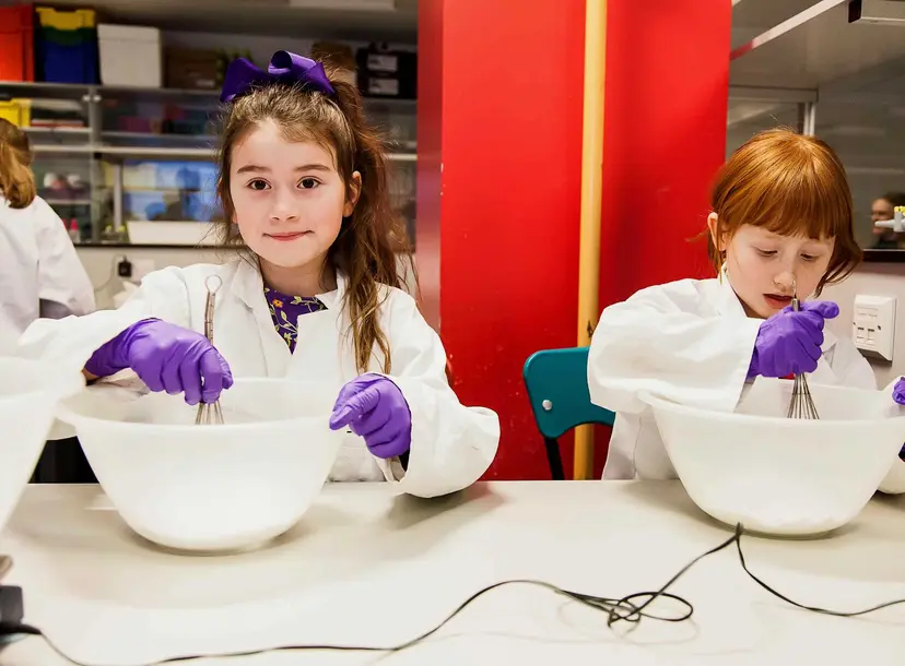 Two participants making bath bombs in the lab