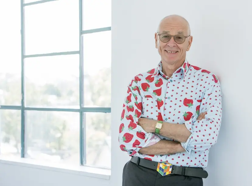 Dr Karl is his usual jazzy shirt, casually leaning against a wall
