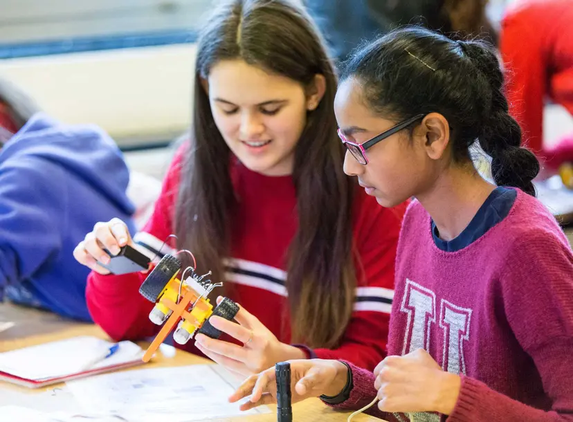 Participants sat at a desk in a workshop
