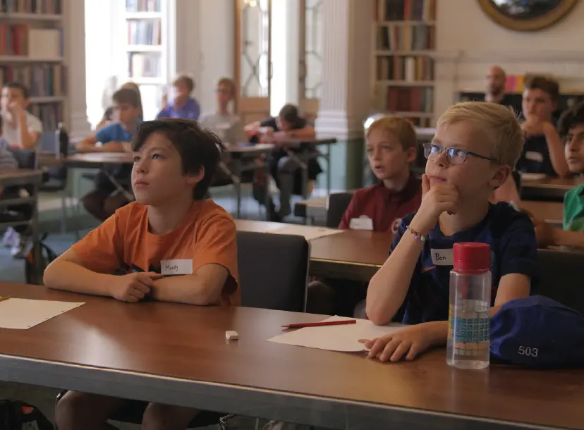 Image of young children sat at a desk