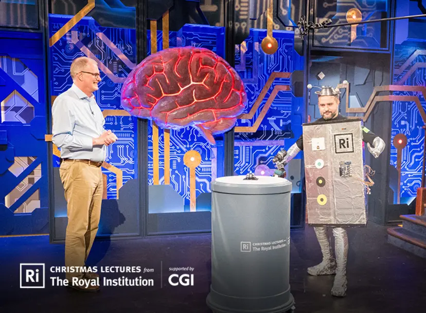 Mike the christmas lecturer is standing alongside our colleague Mike dressed as a robot