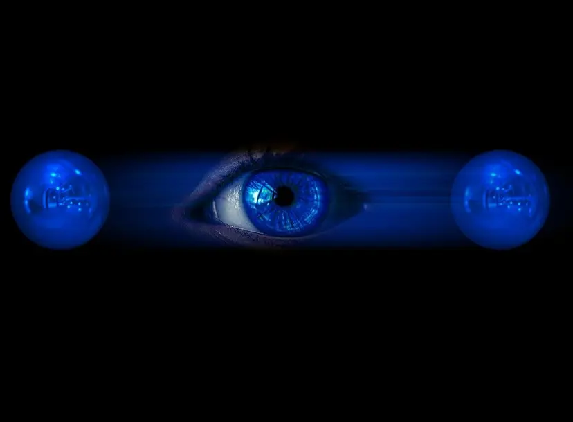 A picture of an eye in between two blue circles. It is an abstract picture of physics. 
