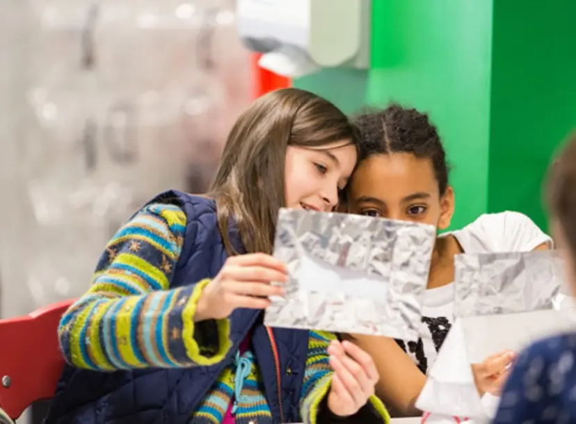 Two participants holding up a foil sheet