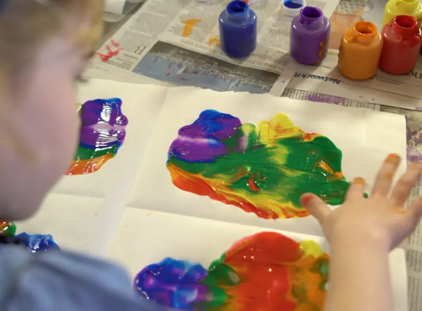 Girl painting using her hands