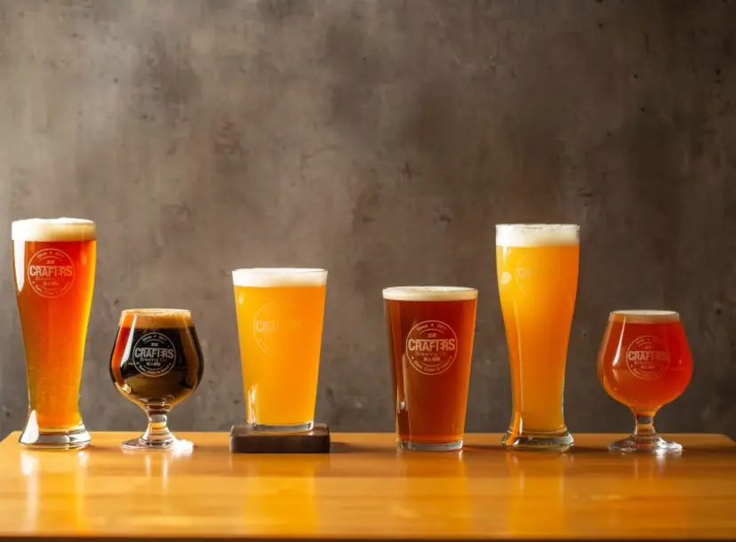 a row of beers in different shapes and sizes.