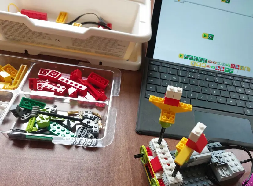 A LEGO creation made using the LEGO WeDo kit next to a laptop