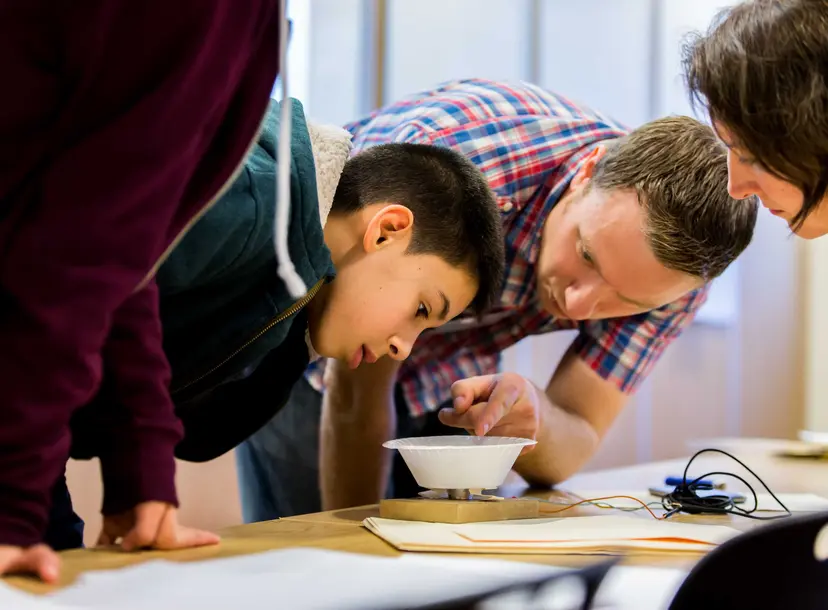 Child testing a homemade speaker created using a bowl