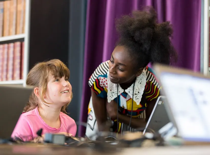 A woman is teaching a child science