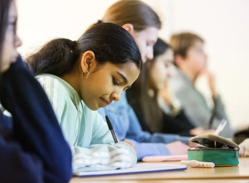 Participants sat at a desk in a workshop
