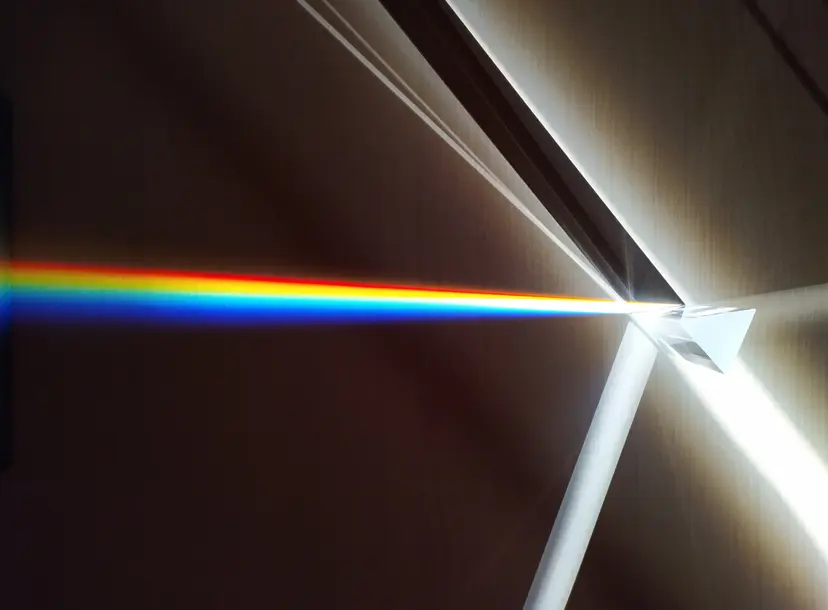 Light shining through a prism and splitting into a rainbow