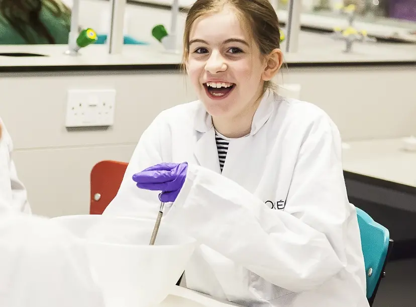 a girl is smiling towards the camera