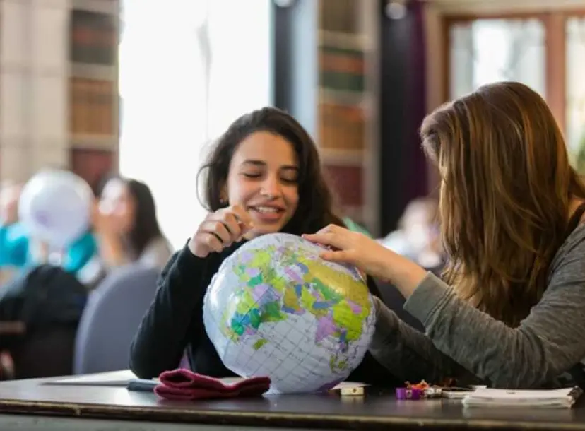 Two participants looking at a globe
