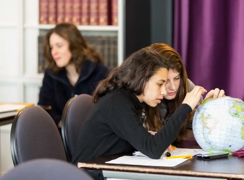 Two participants looking at a globe