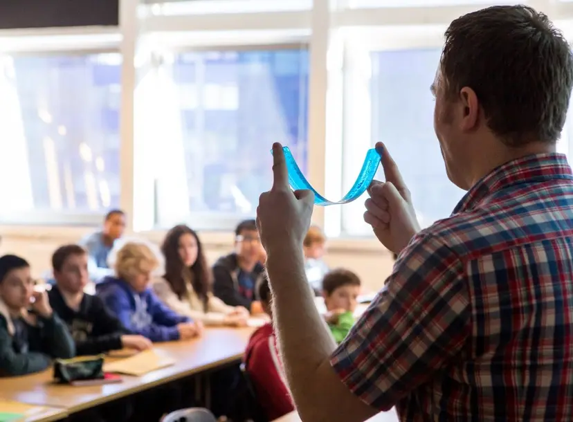 A speaker demonstrates to a class of students