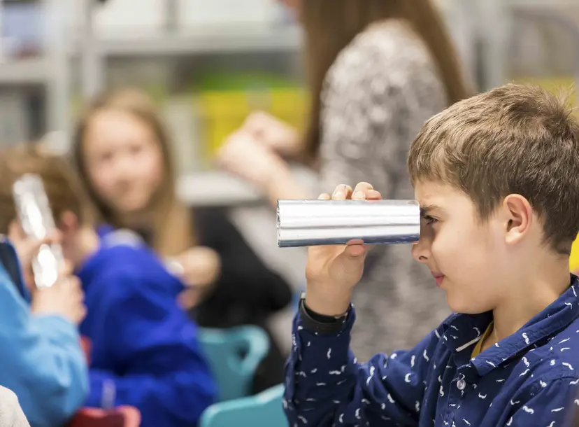 Participant looks through telescope made of foil