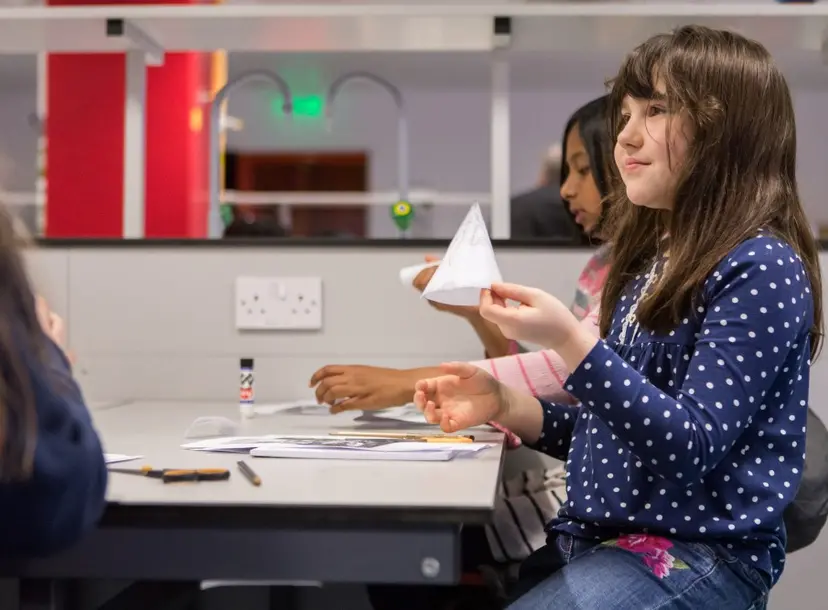 A child holding a paper cone