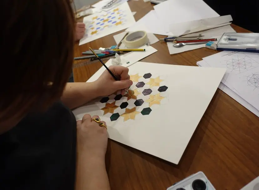 Young people drawing and painting Islamic geometric images