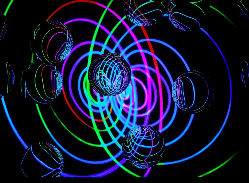 Abstract picture involving clear spheres intersected by lots of different coloured curvy lines. 