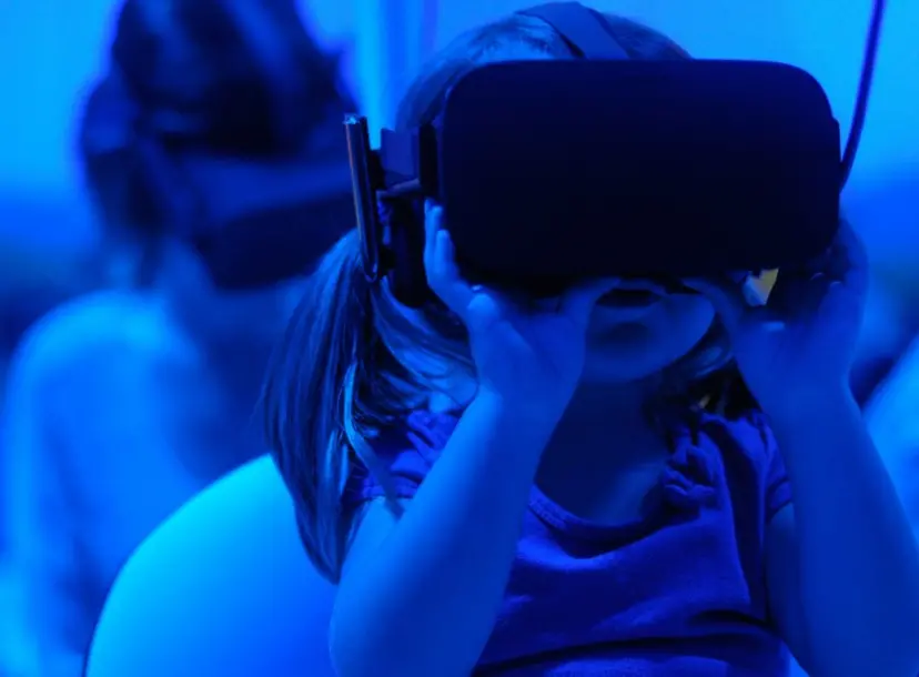 a girl is wearing a VR headset 