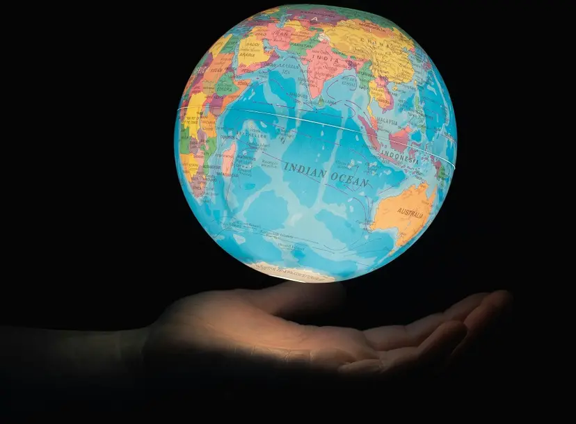 a glowing globe floats above someone's hand